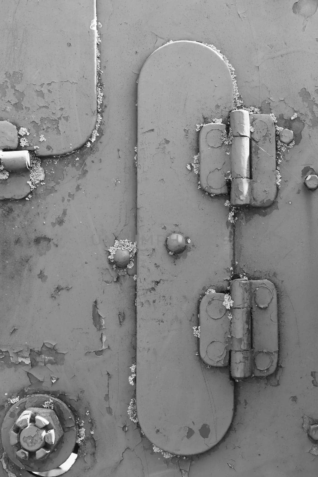 Metal texture with rivets and bolts. Black and white photo.