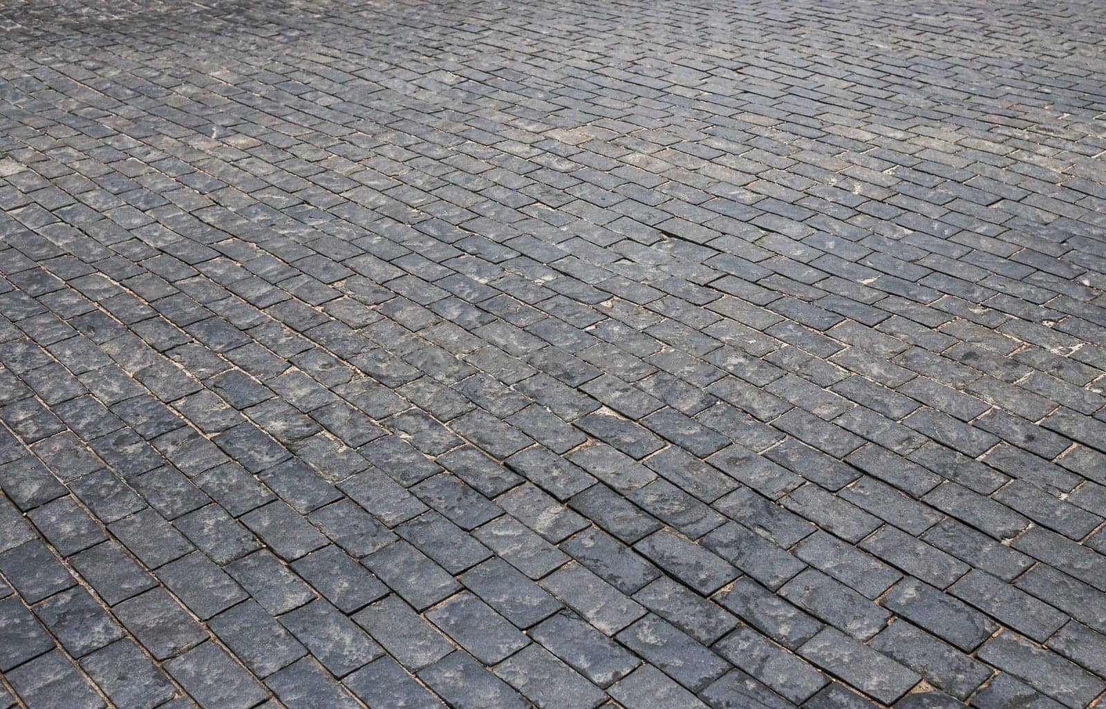 Old cobblestone pavement. Abstract background. Old cobblestone pavement close-up.