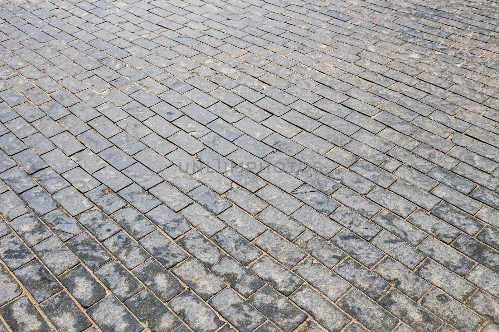 Texture. Abstract background. Old cobblestone pavement close-up.