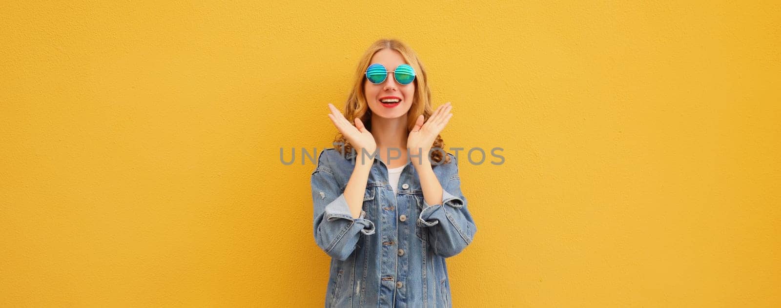 Portrait of stylish happy surprised young woman, cheerful girl posing on bright orange background by Rohappy