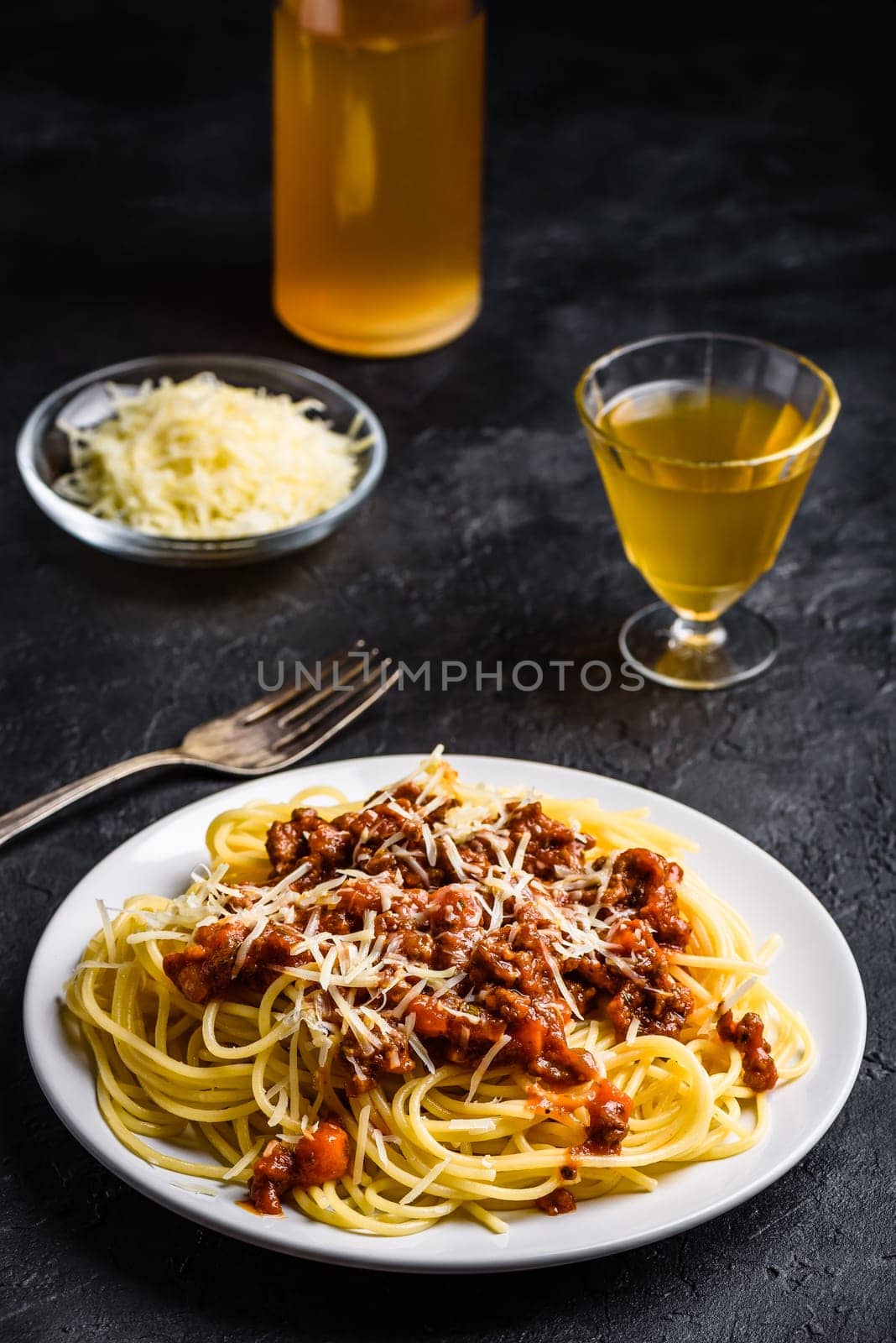 Spaghetti with bolognese sauce and grated parmesan cheese
