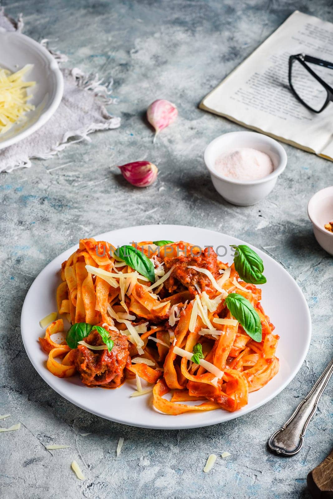 Pasta with mini meatballs, tomato sauce and parmesan cheese