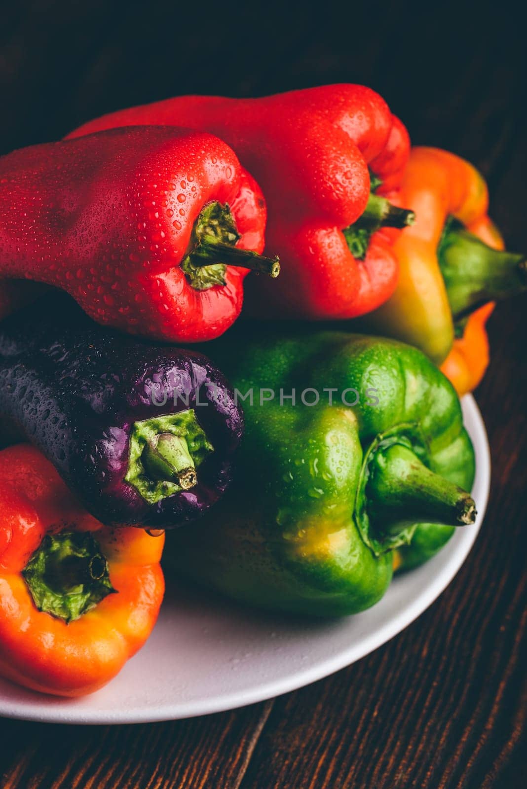 Fresh bell peppers on plate by Seva_blsv