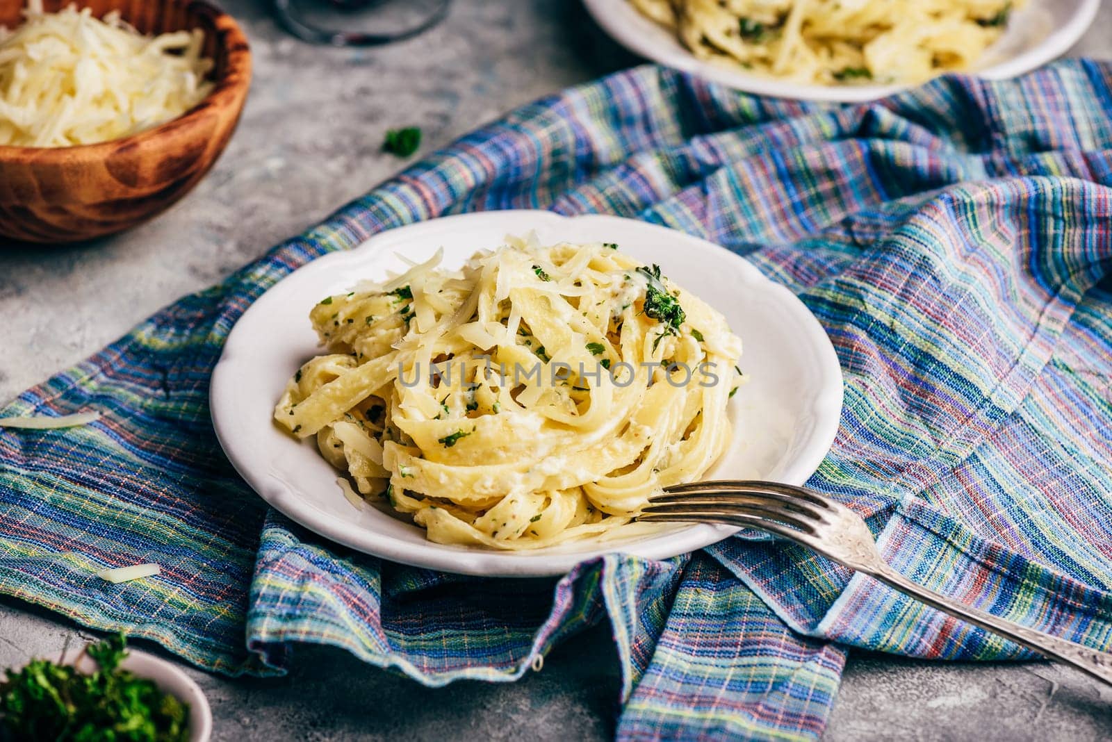 Portions of Homemade Pasta with Alfredo Sauce