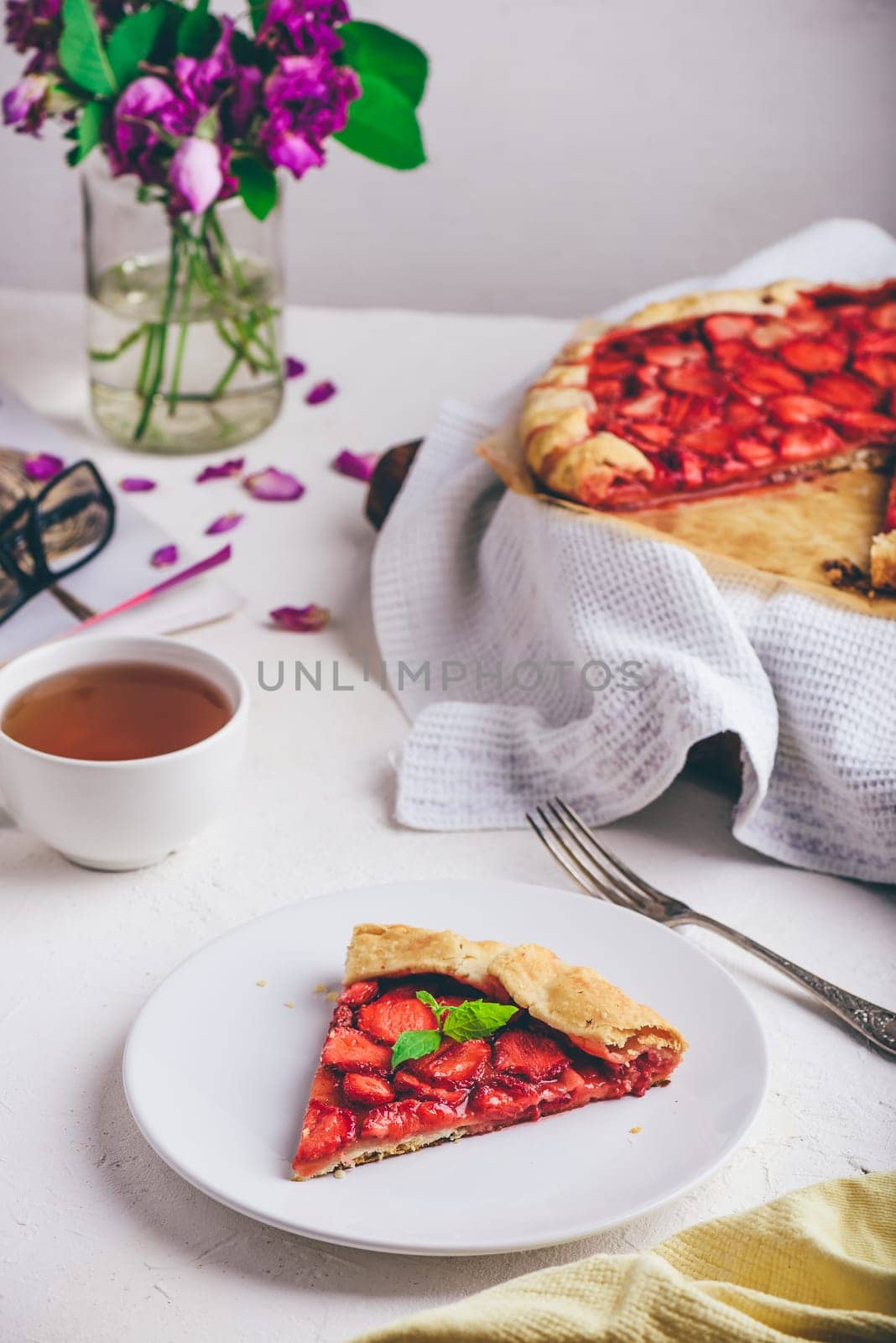 Slice Of Sweet Fresh Baked Strawberry Galette With Mint Leaves On White Plate