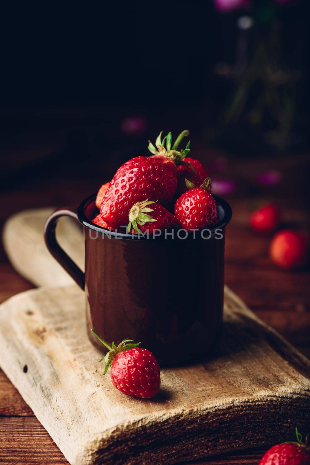 Mug full of fresh strawberries on rustic table by Seva_blsv