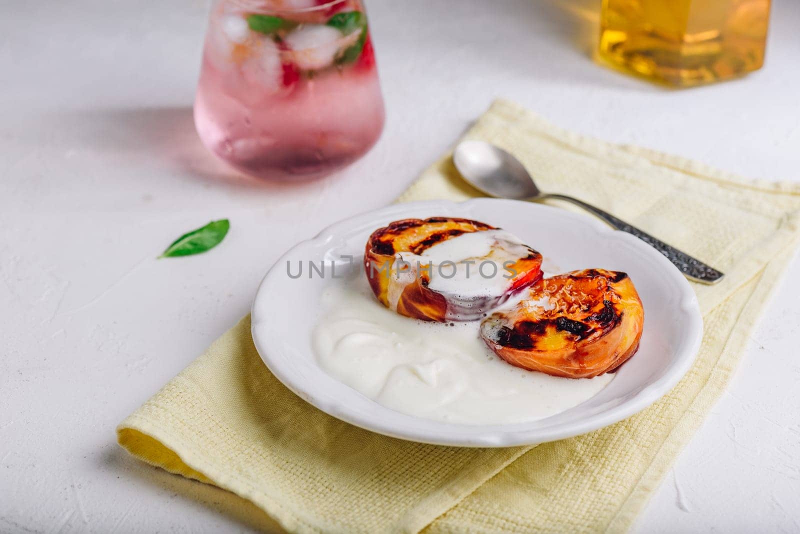 Served Oven Roasted Peaches with Honey and Whipped Heavy Cream on White Plate by Seva_blsv