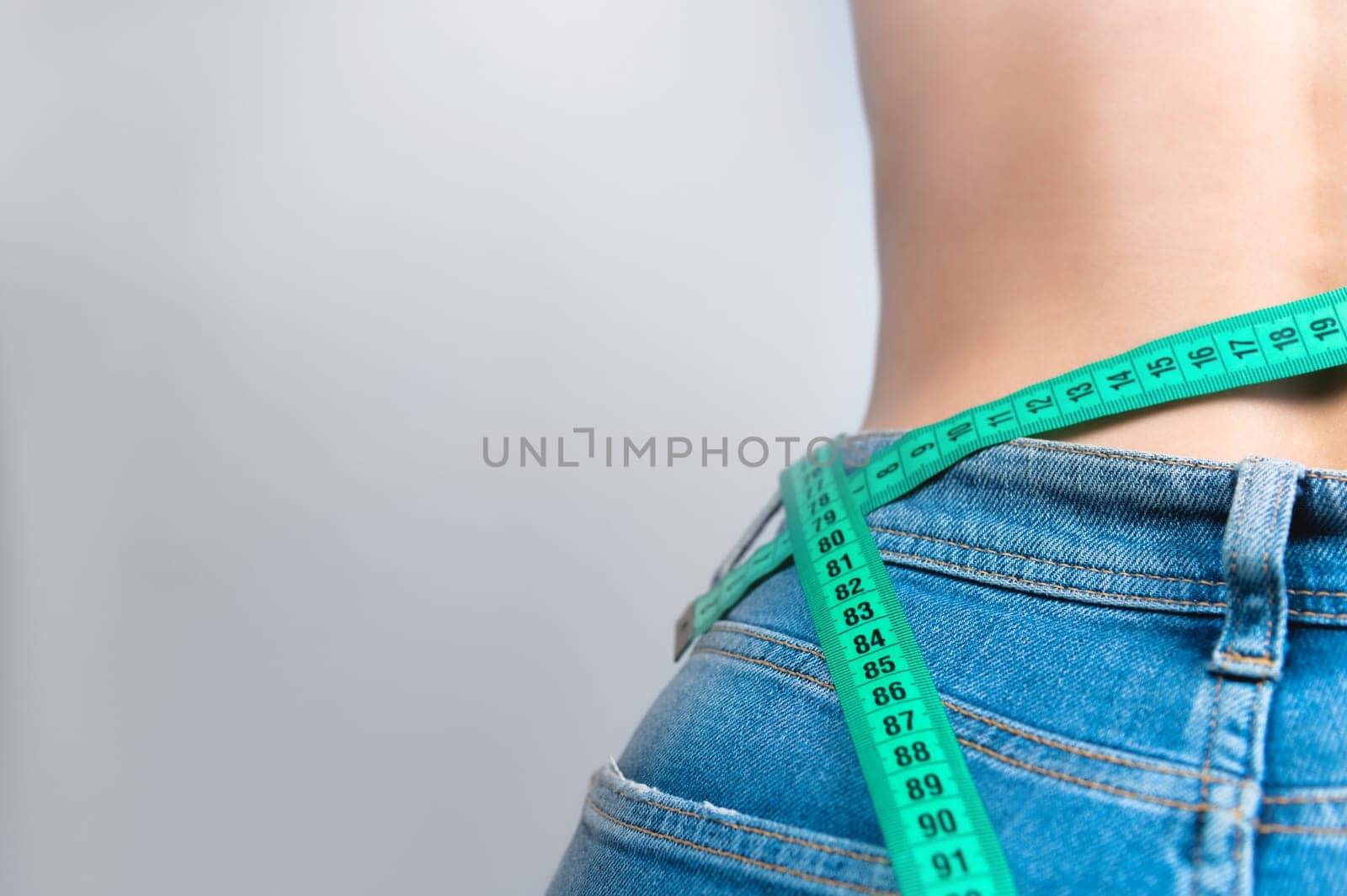 Woman measures the girth around the waist measuring tape. Concept of diet and body weight control, close up, toned by yanik88