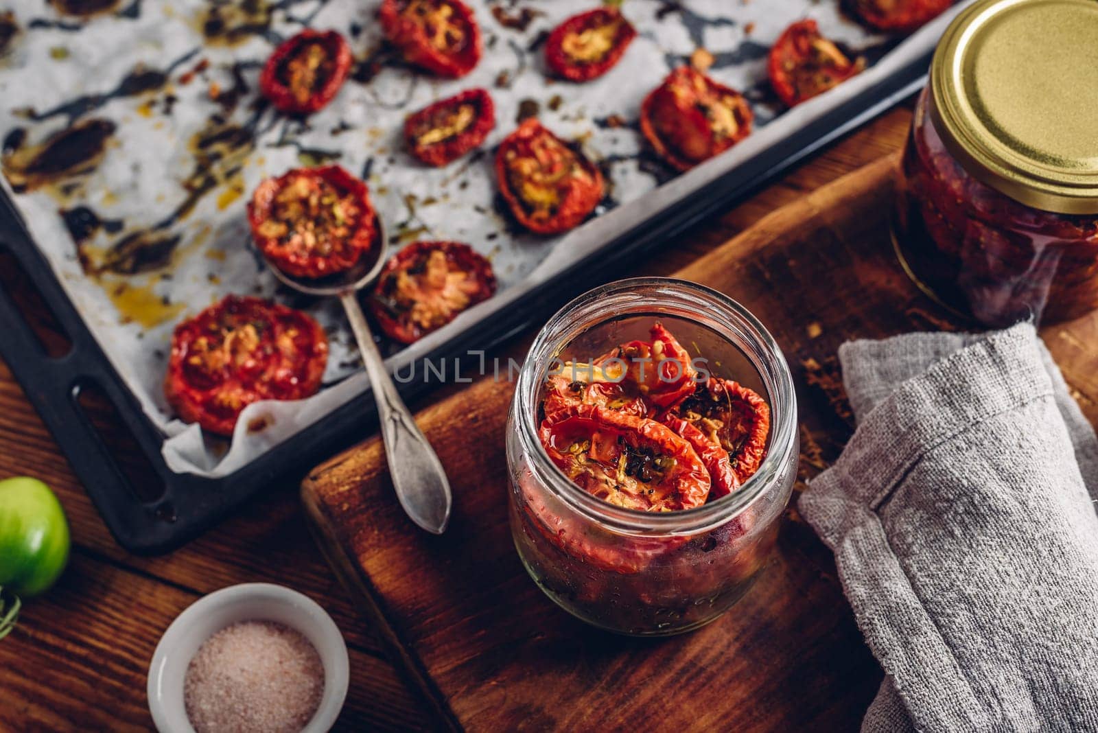 Freshly Oven Baked Tomatoes with Thyme, Garlic and Olive Oil Preserved in a Glass Jar
