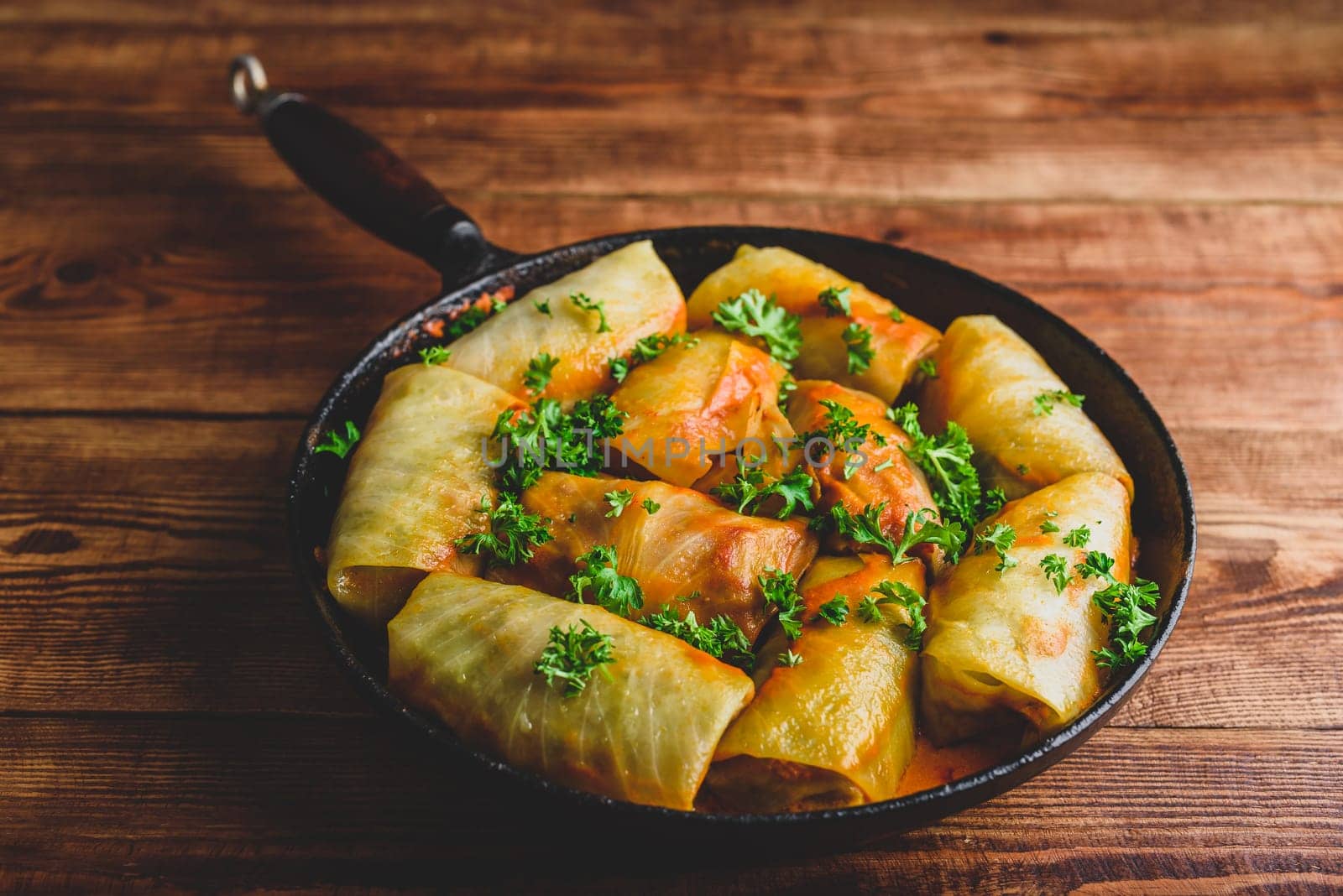 Frying Pan Full of Cabbage Rolls Stuffed with Minced Beef Served with Chopped Parsley by Seva_blsv