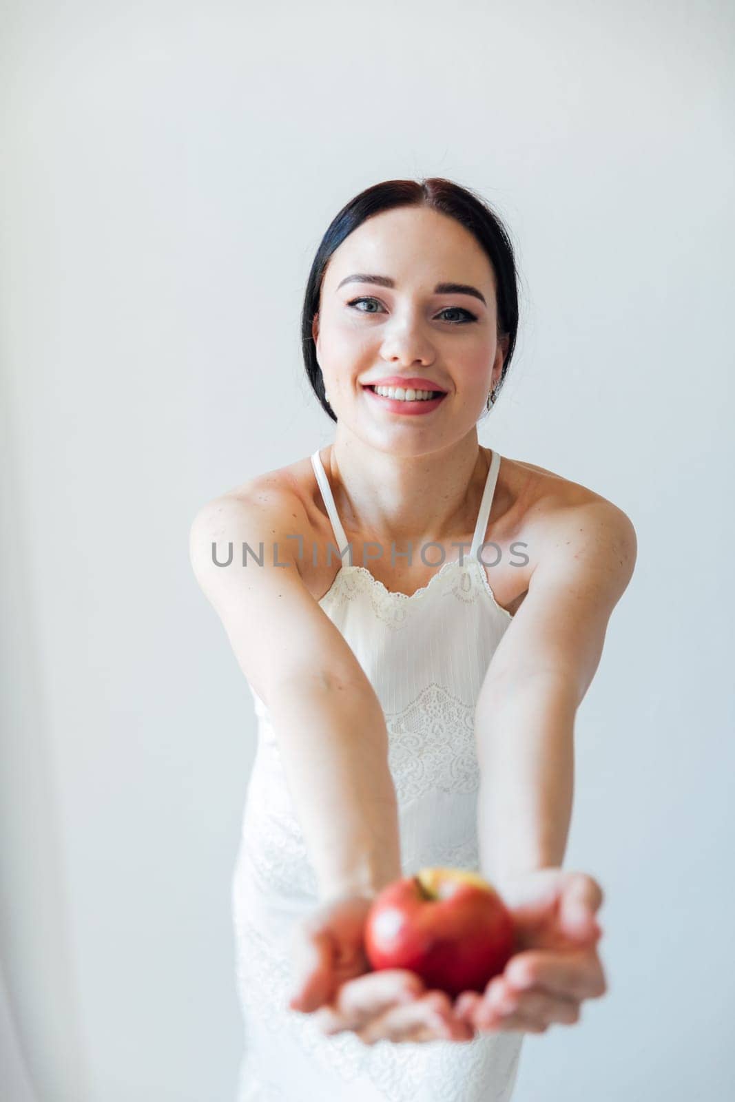 woman holds out an apple food vitamins healthy food