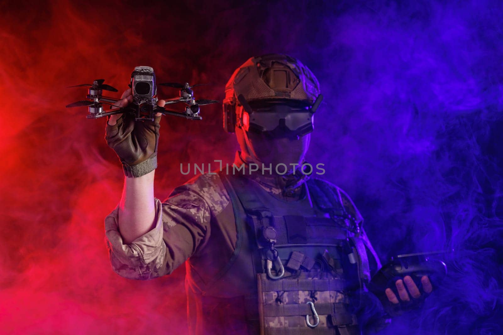 Soldier in gear holds drone against a red and blue smoky background, conveying intensity and military action