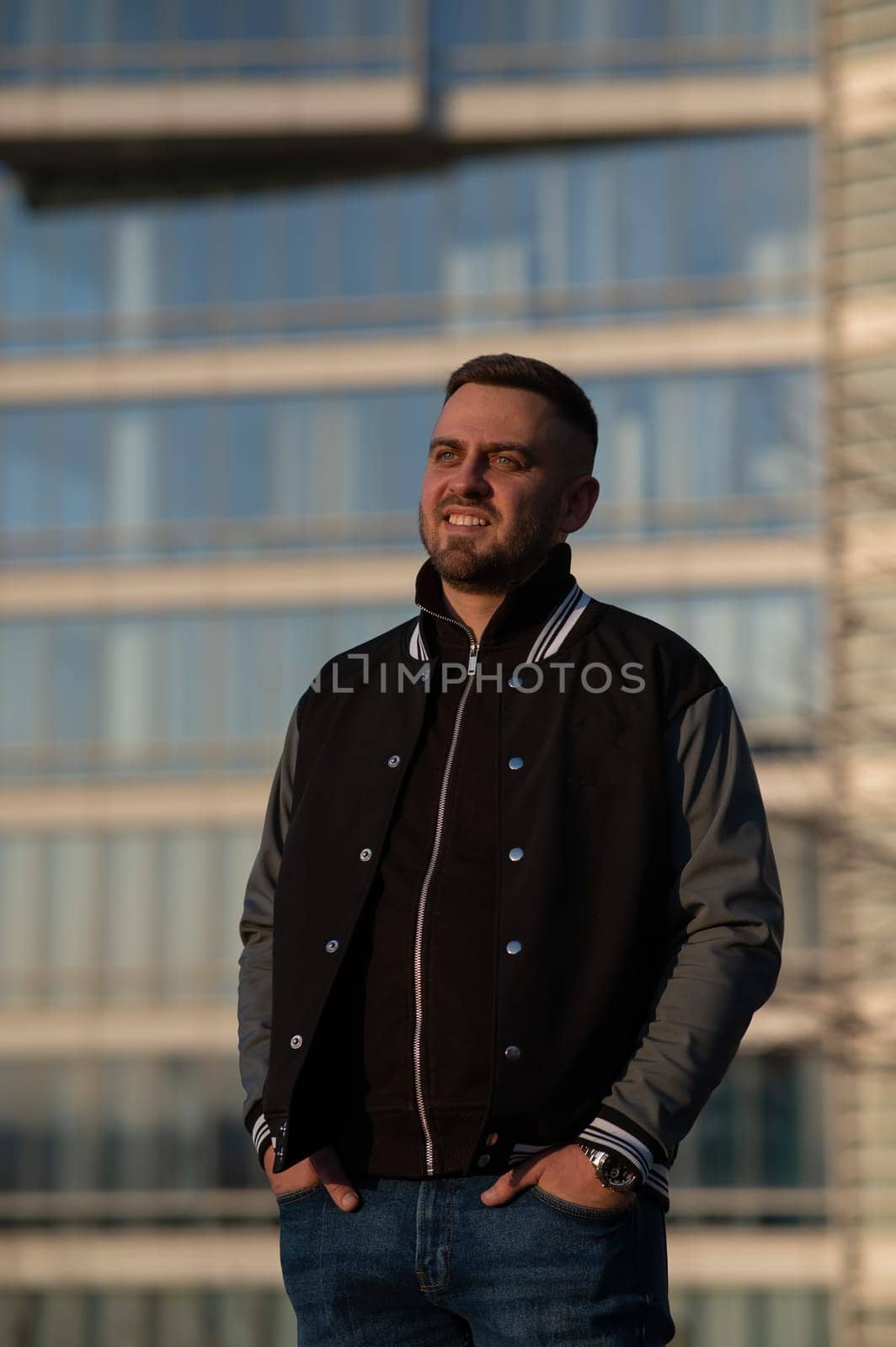 Portrait of a smiling bearded man outdoors at sunset. by mrwed54