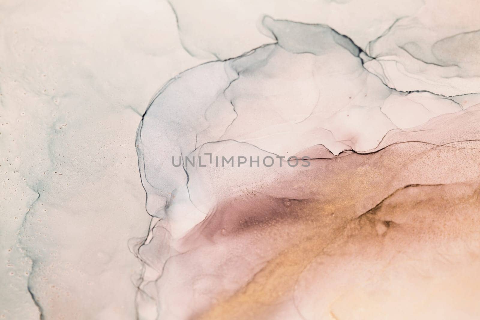 A close-up abstract image of swirling ink in shades of dusty rose and gold, creating a visually captivating and organic texture.