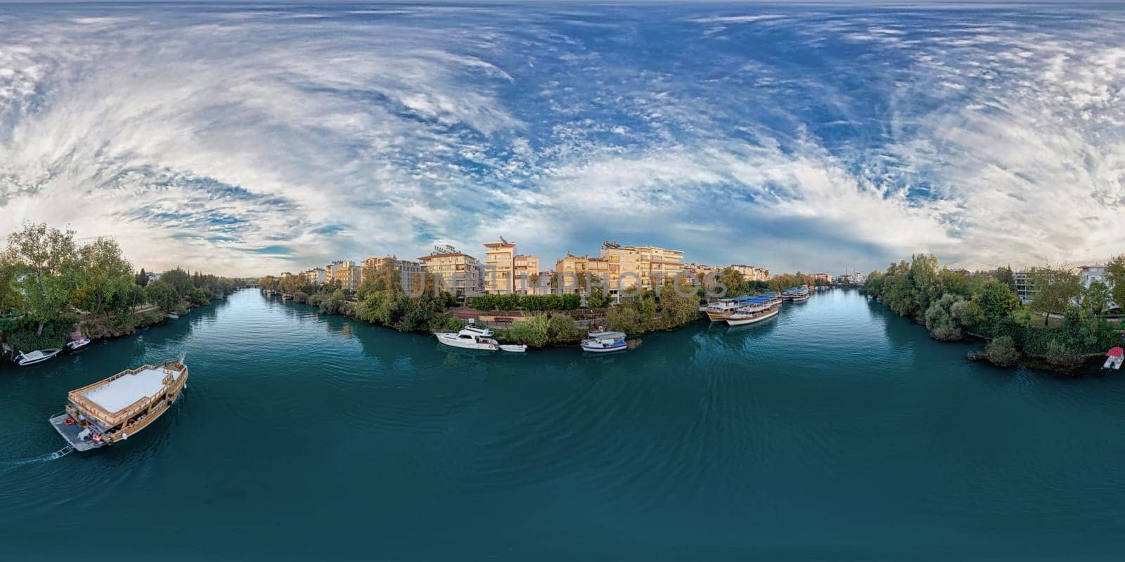 Aerial view of the city of Manavgat, the Manavgat River, the Mediterranean Sea, in the evening at sunset. Antalya region, Turkey.