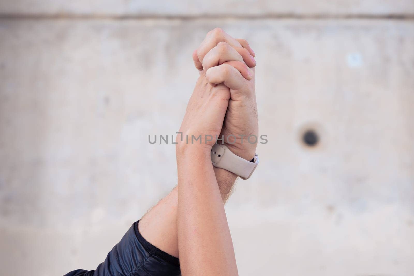 Unrecognizable couple holding hands outdoors by mariaphoto3