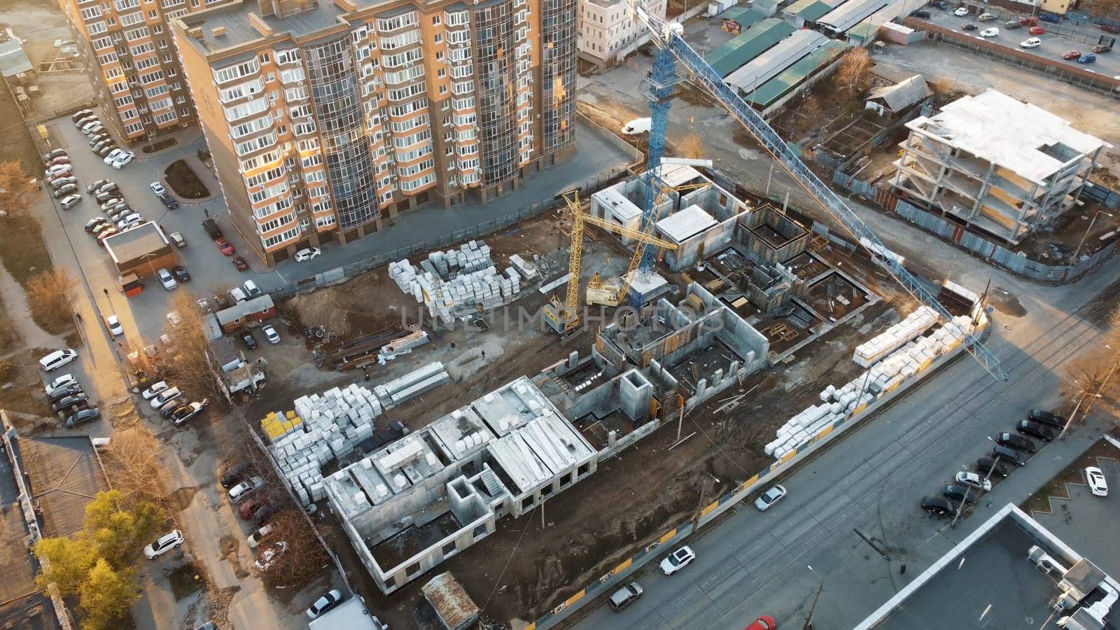 An urban design landscape featuring a skyscraper tower under construction in the city, showcasing a modern facade and roof of the condominium building
