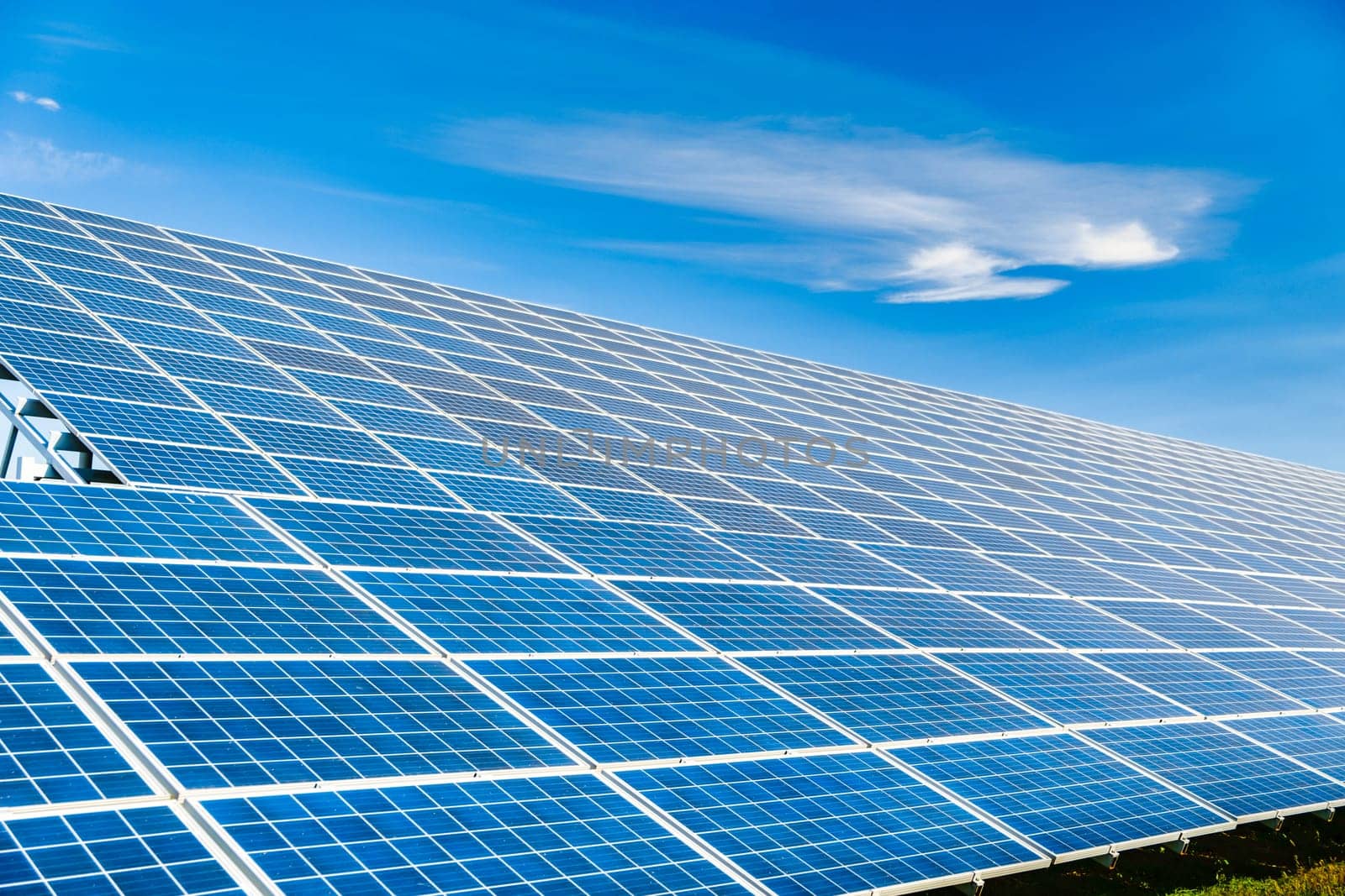 Photovoltaic modules of huge solar panels with blue sky on background. concept of sustainable resources.
