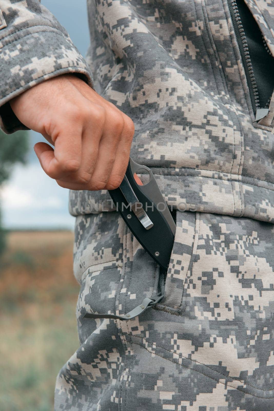 A man with a knife in the forest. Travel or military concept