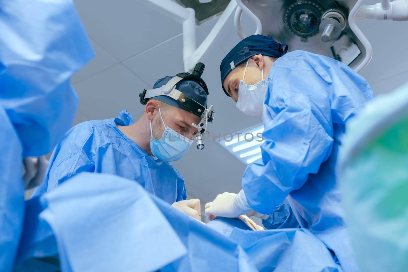 male surgeons perform surgery in operating room, plastic surgeon in operating room, A surgical team is carrying out an operation