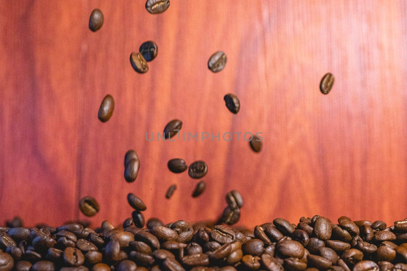 Roasted coffee beans flying in the air. Background for coffee.