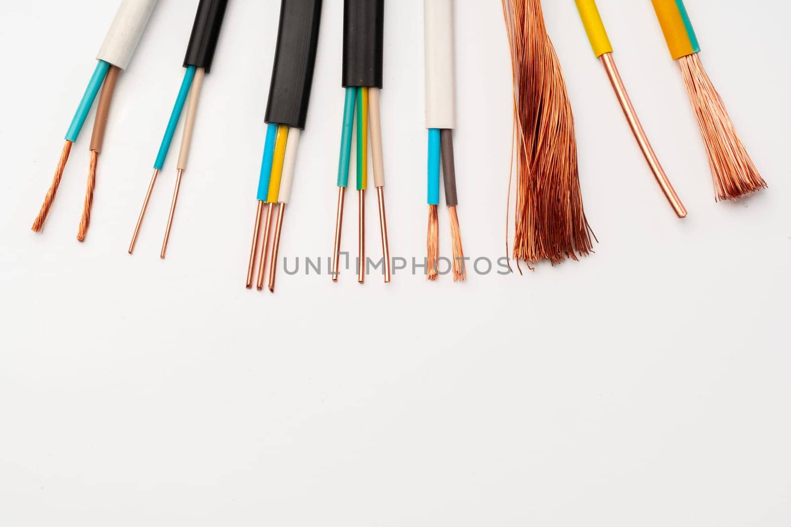 A close-up image showcasing various types of electrical wires with exposed copper strands on a white background.