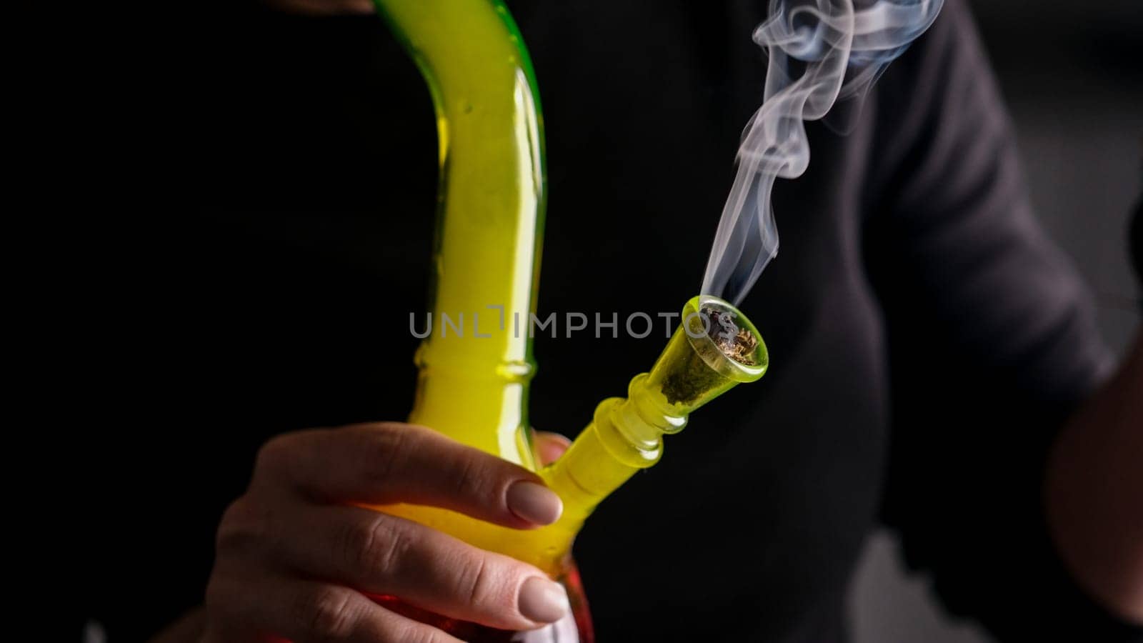Woman Smokes Cannabis With Bong In Close-Up View