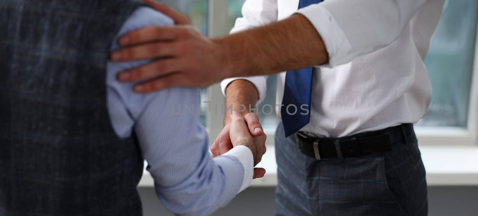 Man in suit and tie give hand as hello in office closeup. Friend welcome mediation offer positive introduction thanks gesture summit executive approval motivation male arm strike bargain
