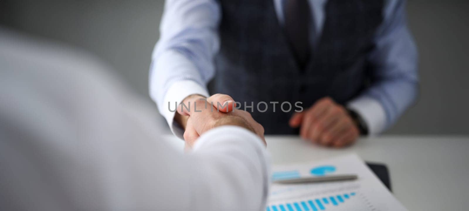 Man in suit and tie give hand as hello in office closeup. Friend welcome mediation offer positive introduction thanks gesture summit executive approval motivation male arm strike bargain