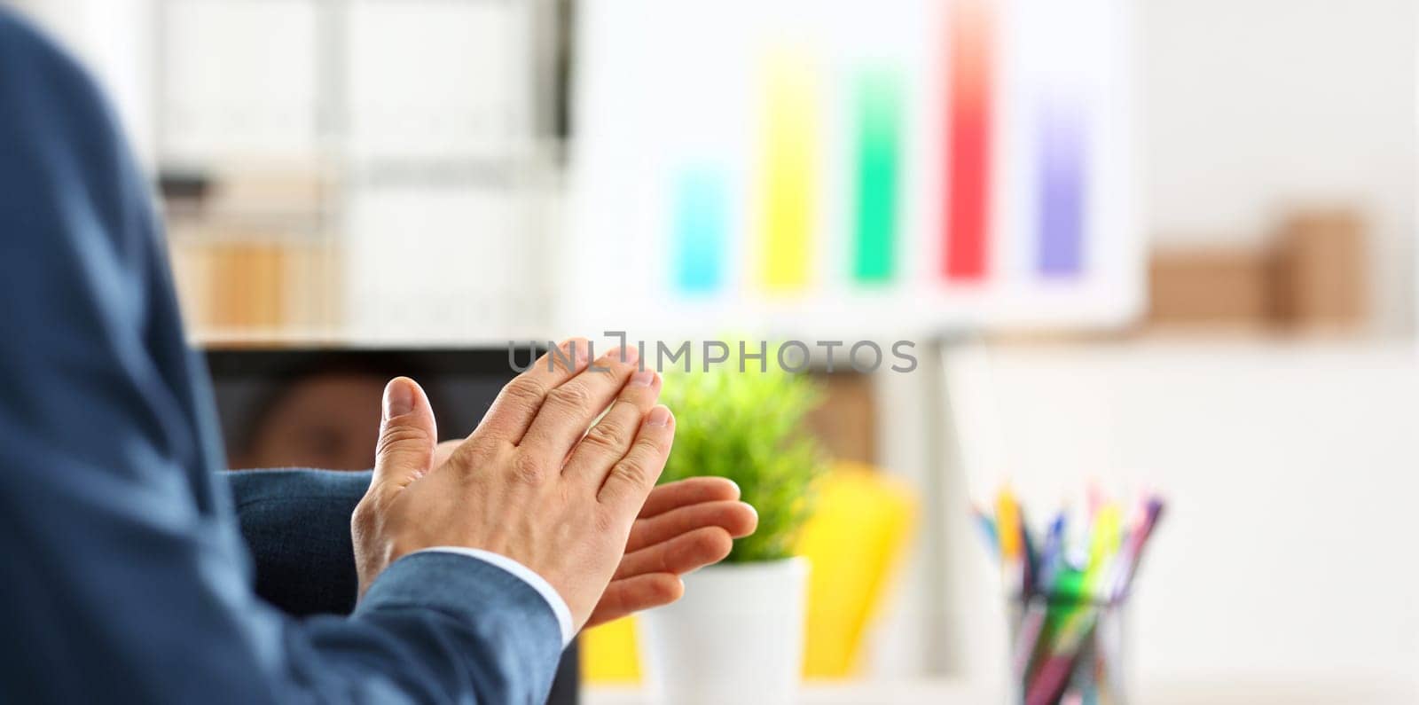 Man in suit clap his arms congrats for successful seminar in office closeup. Thank symbol great lecture job emotion worker introduce colleague negotiation happy birthday win career project idea
