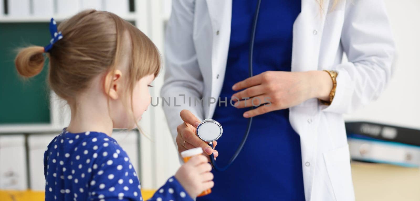 Little child with stethoscope at doctor reception. Physical exam cute infant portrait baby aid healthy lifestyle ward round child sickness specialist clinic test pulse concept