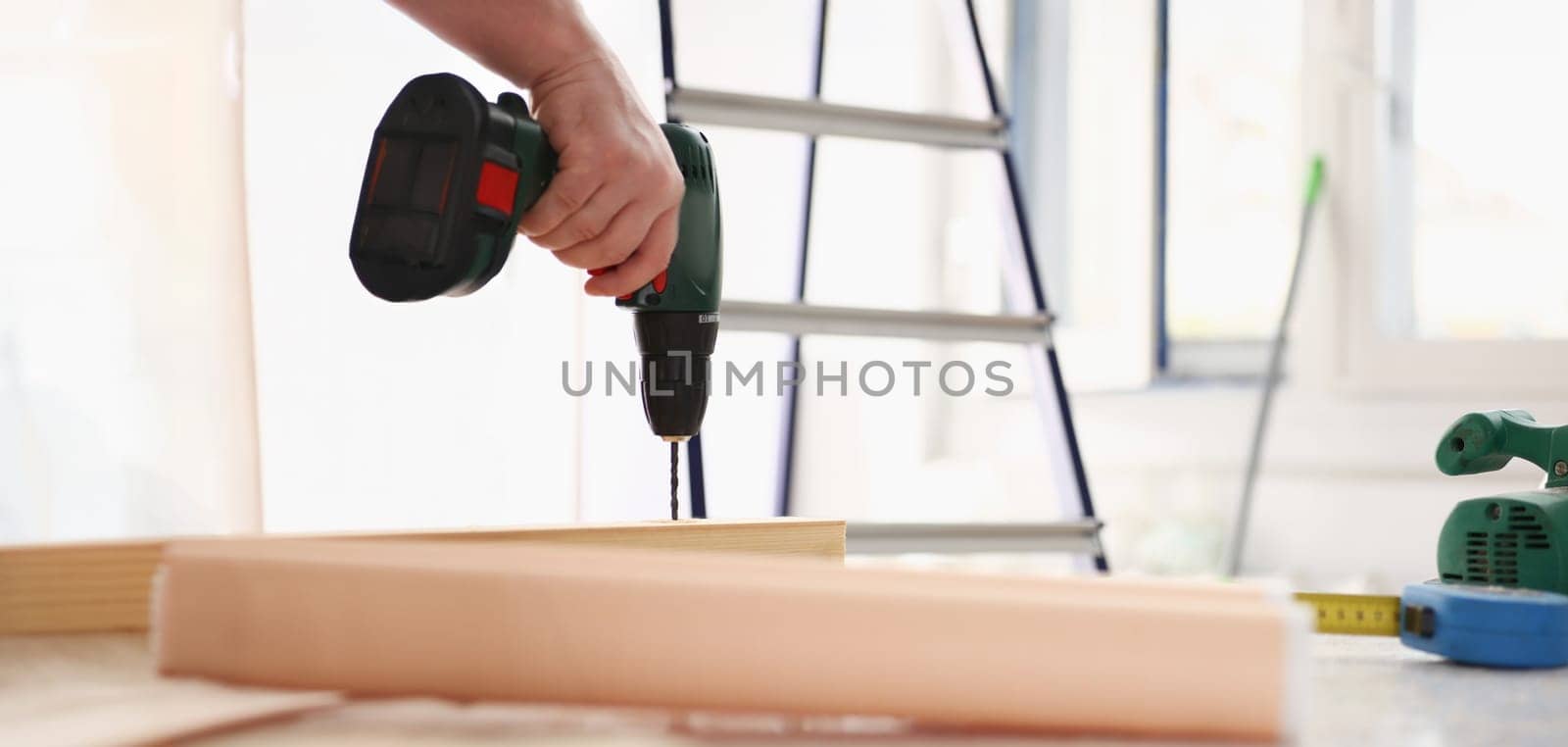 Flat drill bit make hole in wooden bar closeup. DIY job inspiration improvement fix shop powersaw bench joinery startup workplace idea career shaving industrial education concept