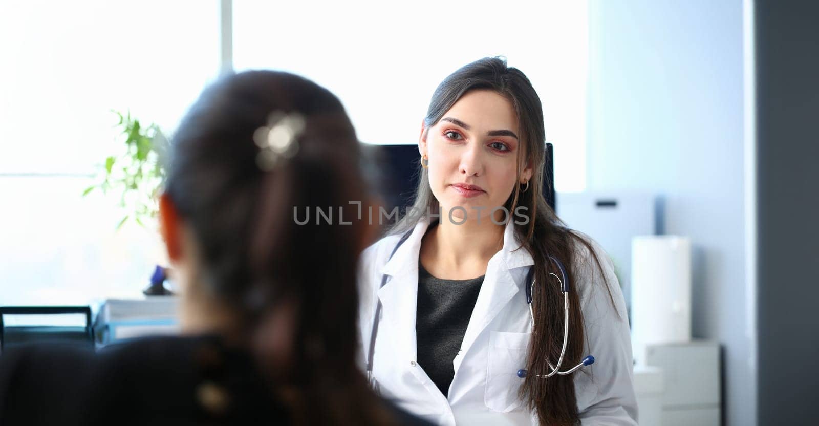 Beautiful smiling female doctor talk with patient about his history list. Physical exam er anamnesis communication disease prevention ward round 911 prescribe remedy healthy lifestyle concept