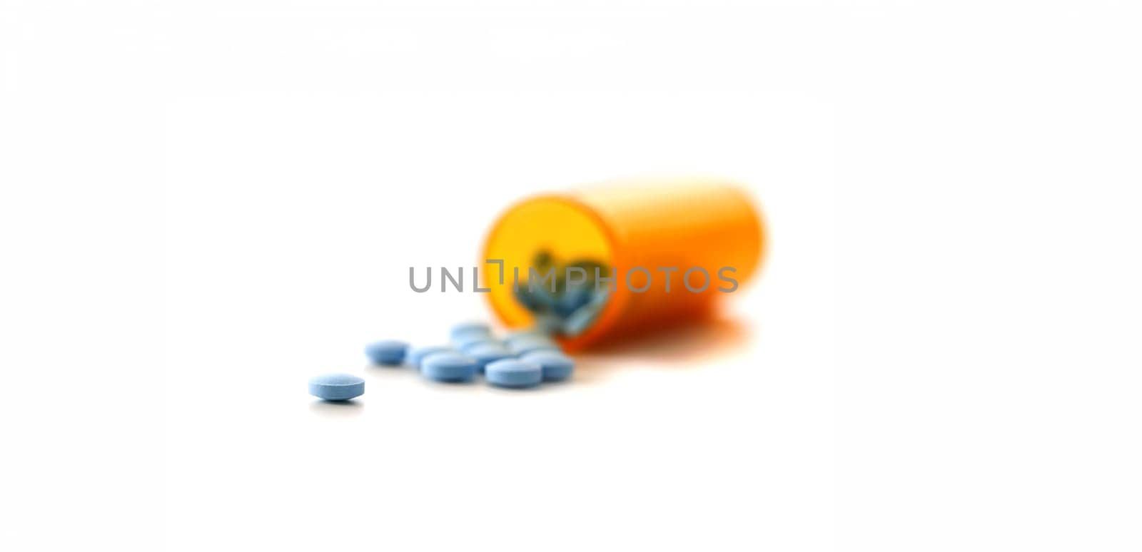 Tablets scattered blue color jar on the table of pharmaceutical laboratory pill for the prescription and treatment various diseases chemistry