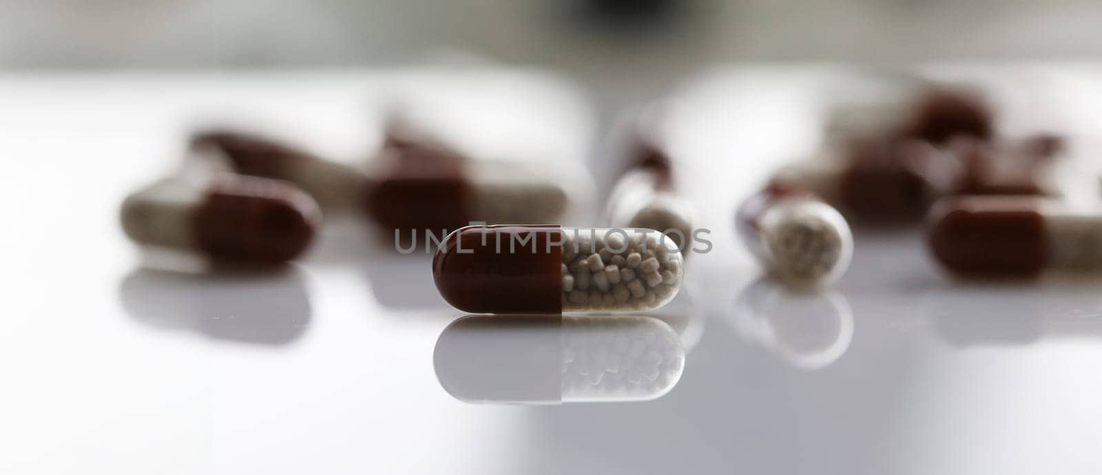 Tablets scattered on the table of the pharmaceutical laboratory pill for the prescription and treatment of various diseases chemistry
