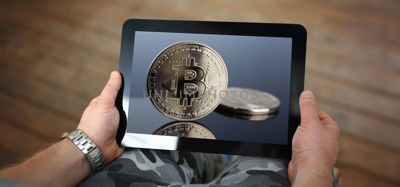 Hipster arms hold tablet pc with btc sign coins at display closeup. Modern pay and buy system symbol idea virtual earning and anti fraud transactions broker education and career success ambition