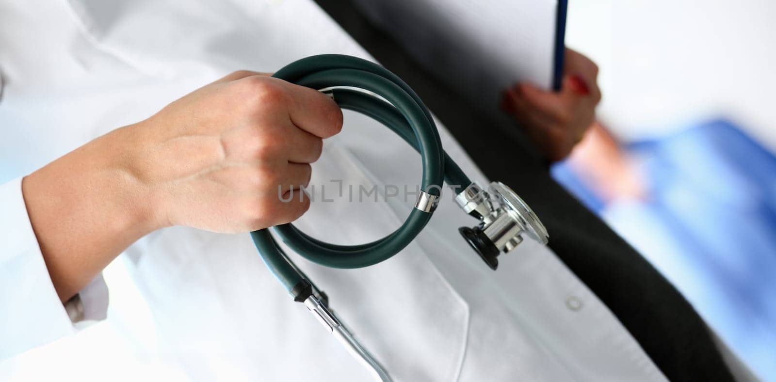 Female doctor hand hold phonendoscope in medical hospital resuscitation background