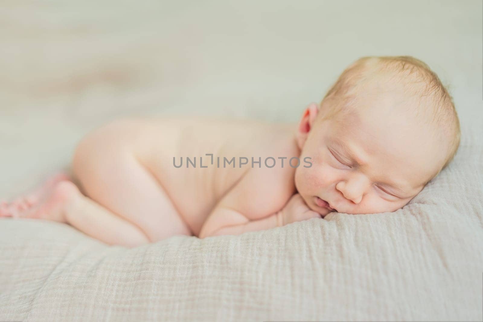 The baby is sleeping peacefully in his cozy nest. Newborn photo session captures the serene innocence and warmth of early moments.