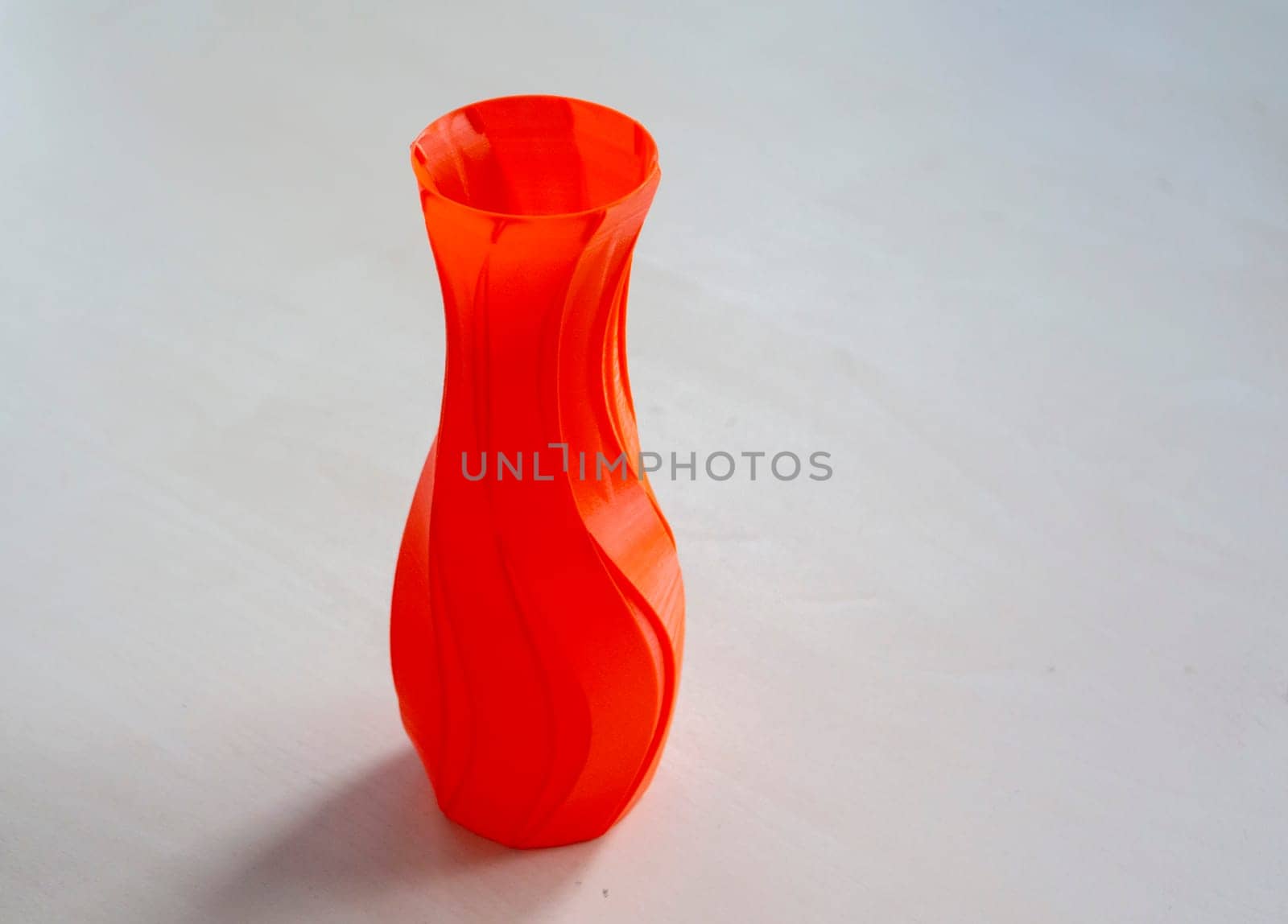 Object form vase of red color printed on a 3D printer. Three-dimensional model by Mari1408