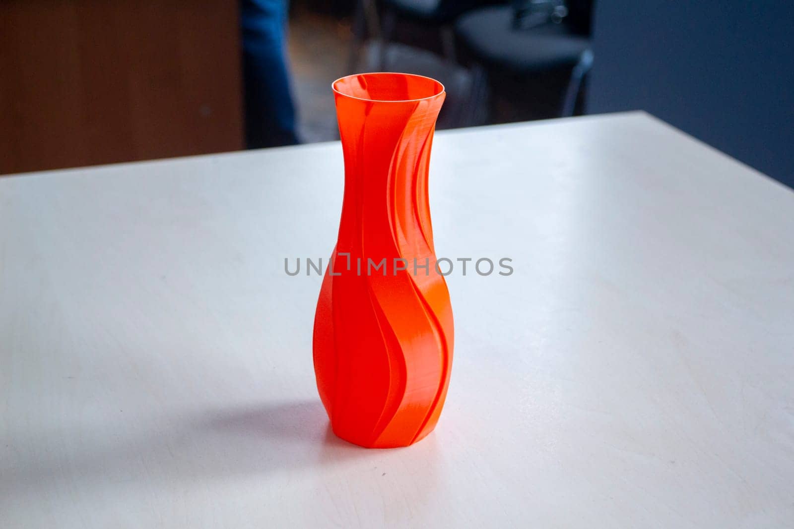 Object in the form of a vase of red color printed on a 3D printer. Three-dimensional model printed on a 3D printer from molten plastic of red color. Concept 3D Printing. FDM 3D Printing technology