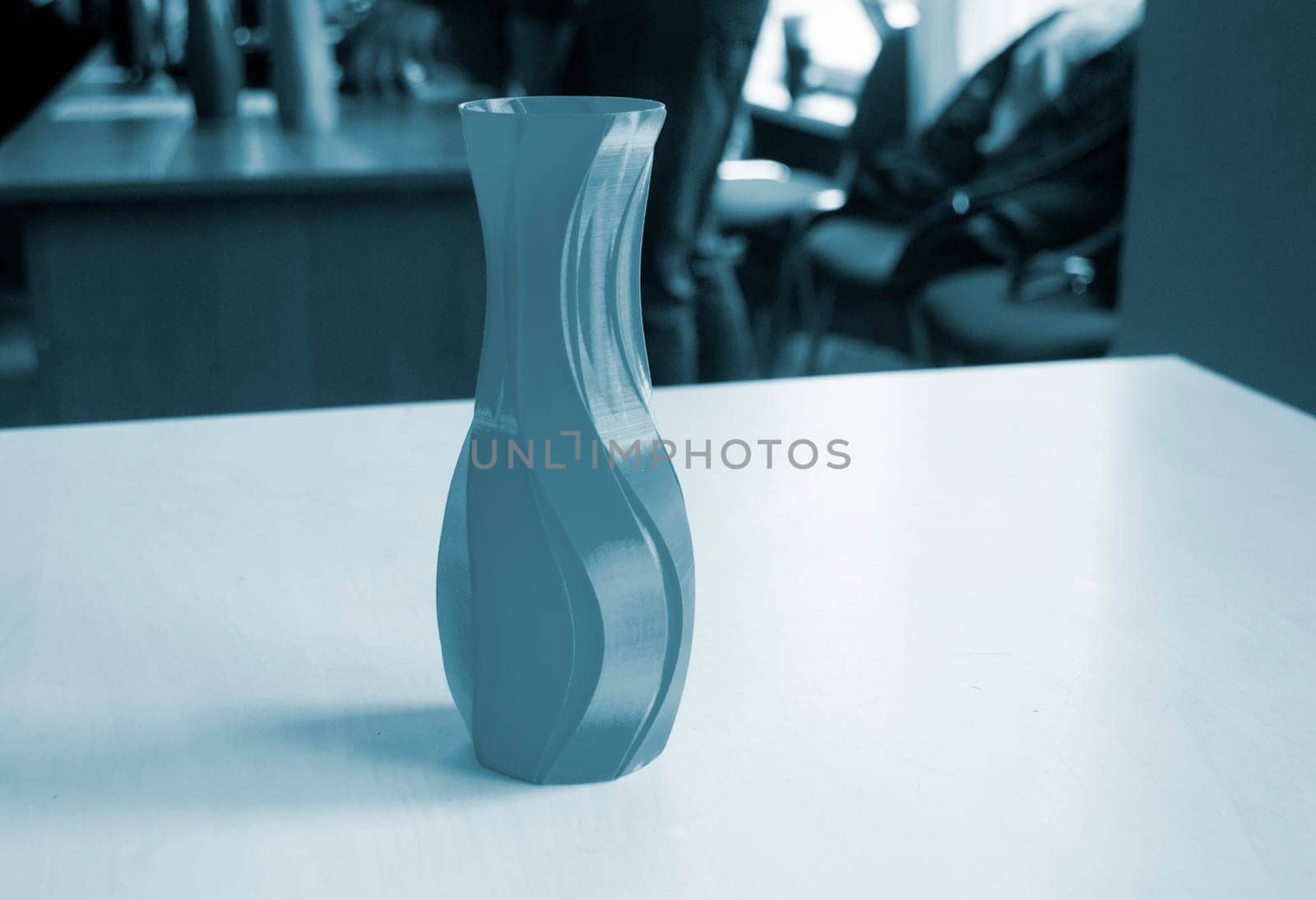 Object in the form of a vase of blue color printed on a 3D printer. Three-dimensional model printed on a 3D printer from molten plastic of red color. Concept 3D Printing. FDM 3D Printing technology
