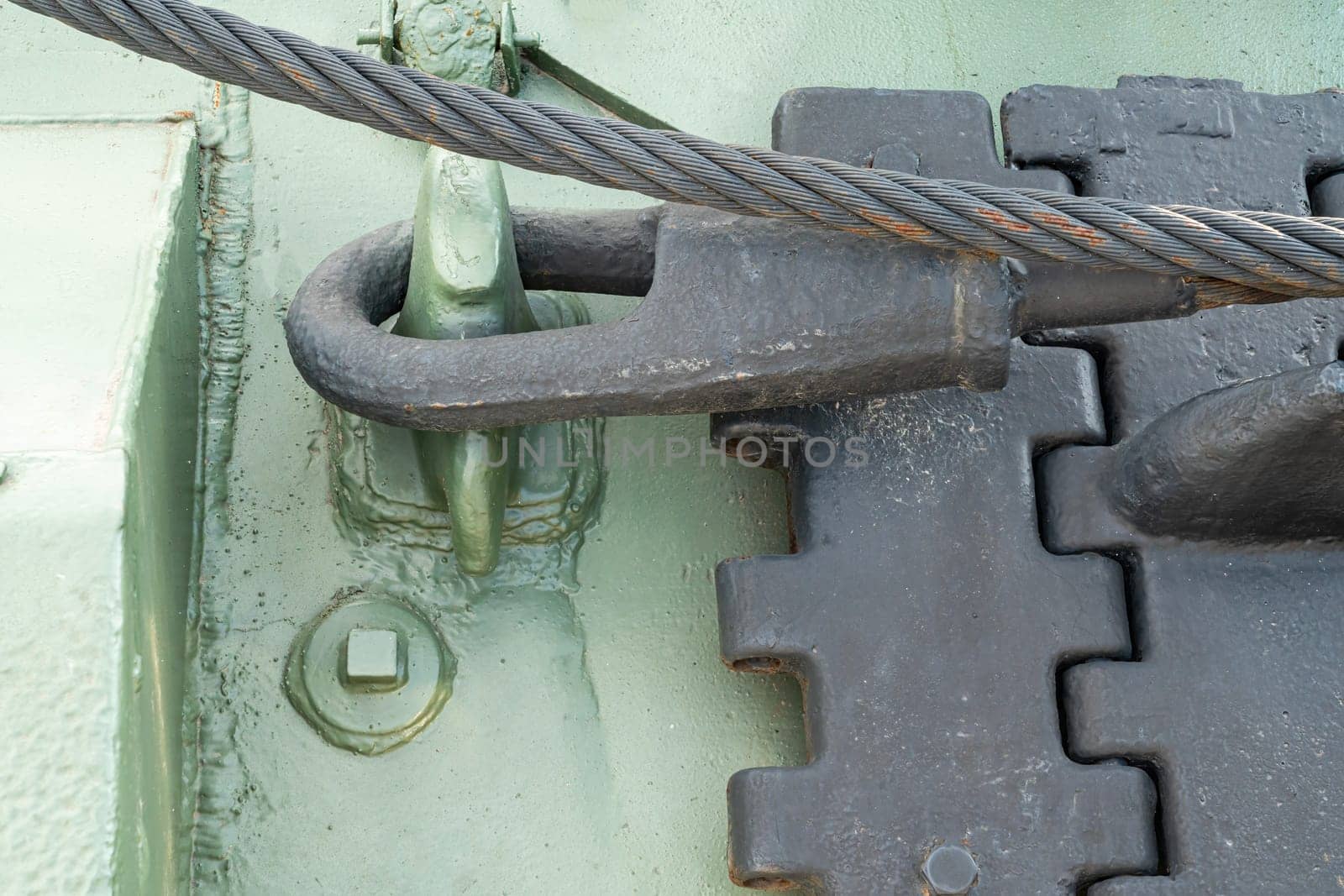 a green tank track in close-up on the asphalt. photo