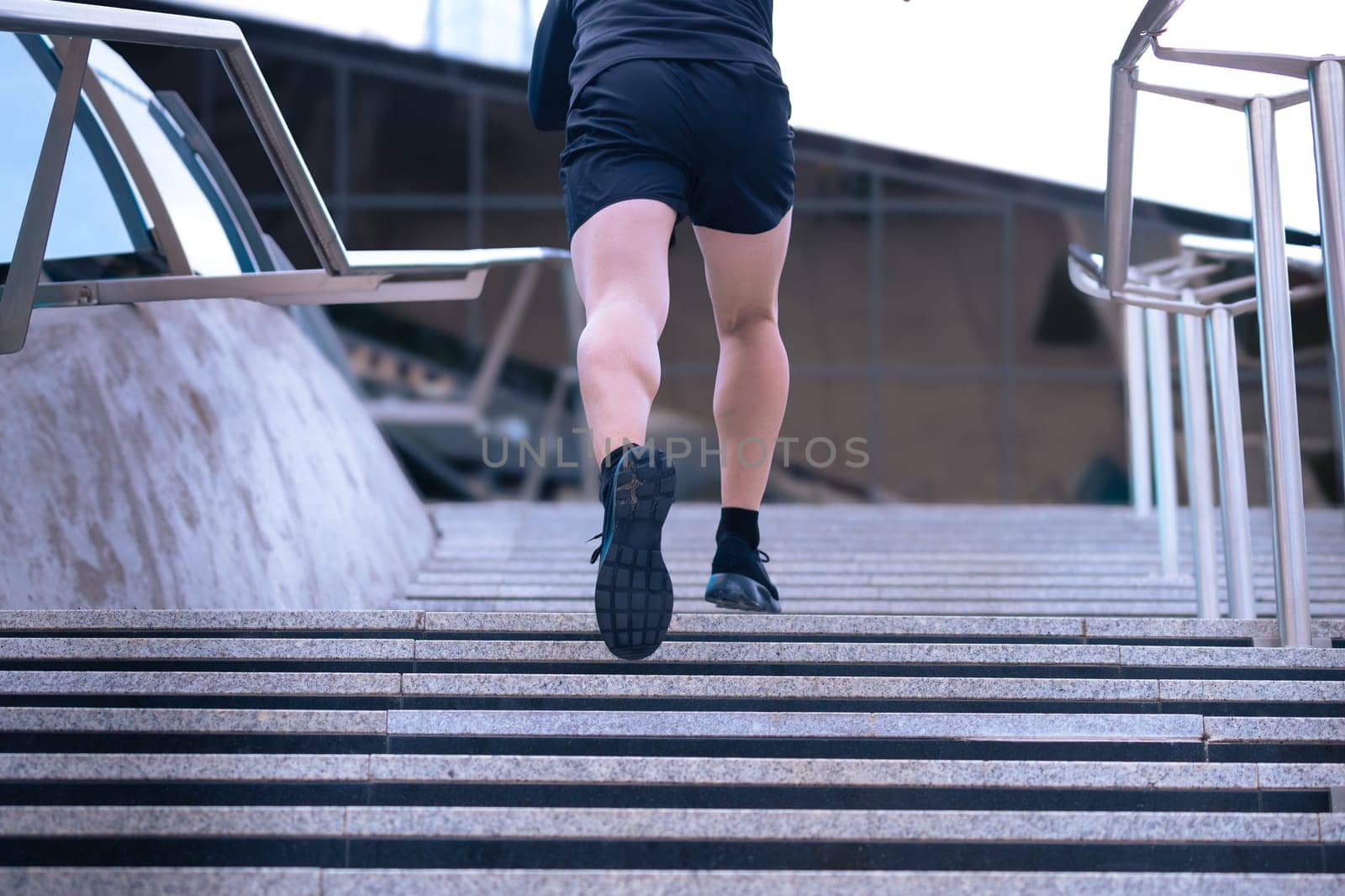 Unrecognizable Athlete, running down the stairs, doing dynamic exercise outdoors by molesjuny