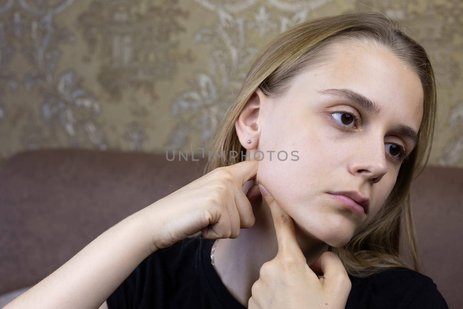 Girl massages her face to smooth out wrinkles and improve skin health at home, special facial skin care procedure