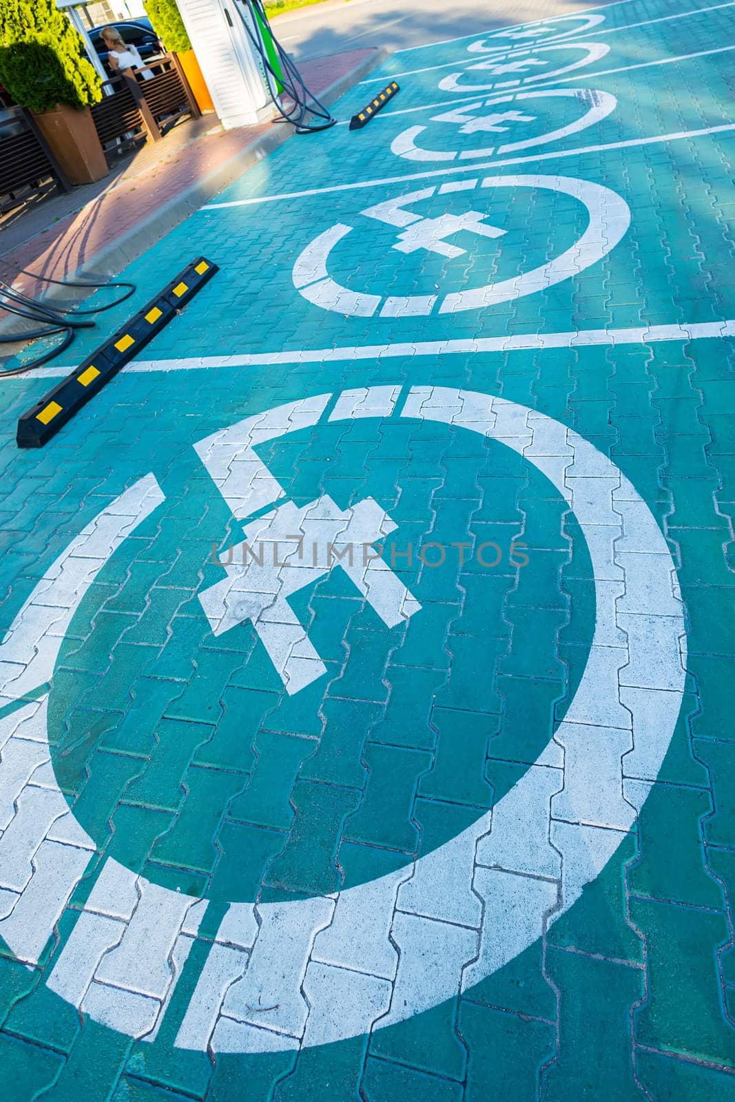 Parking lots for electric cars only. Charging stations stand in a row. Electric car sign