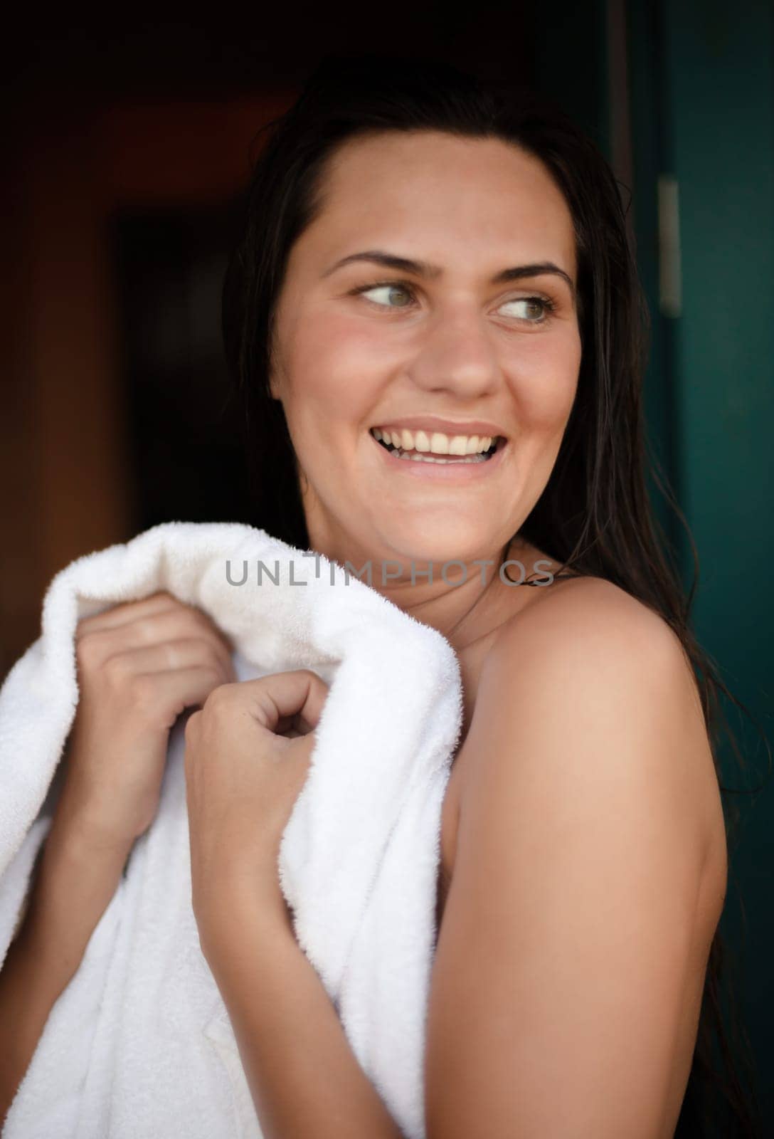 Morning at the campsite. Young naked woman wipes herself with a towel after a shower at a campsite.