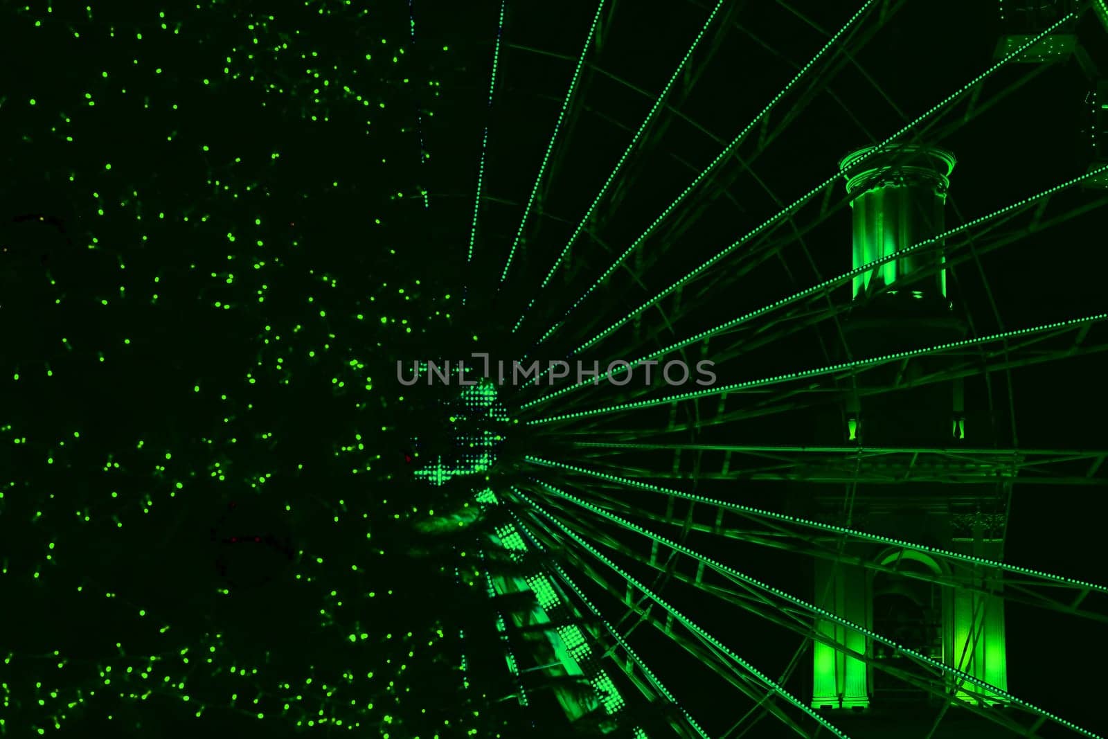 Green abstract illuminated ferris wheel,night.Amusement,pleasure by jovani68