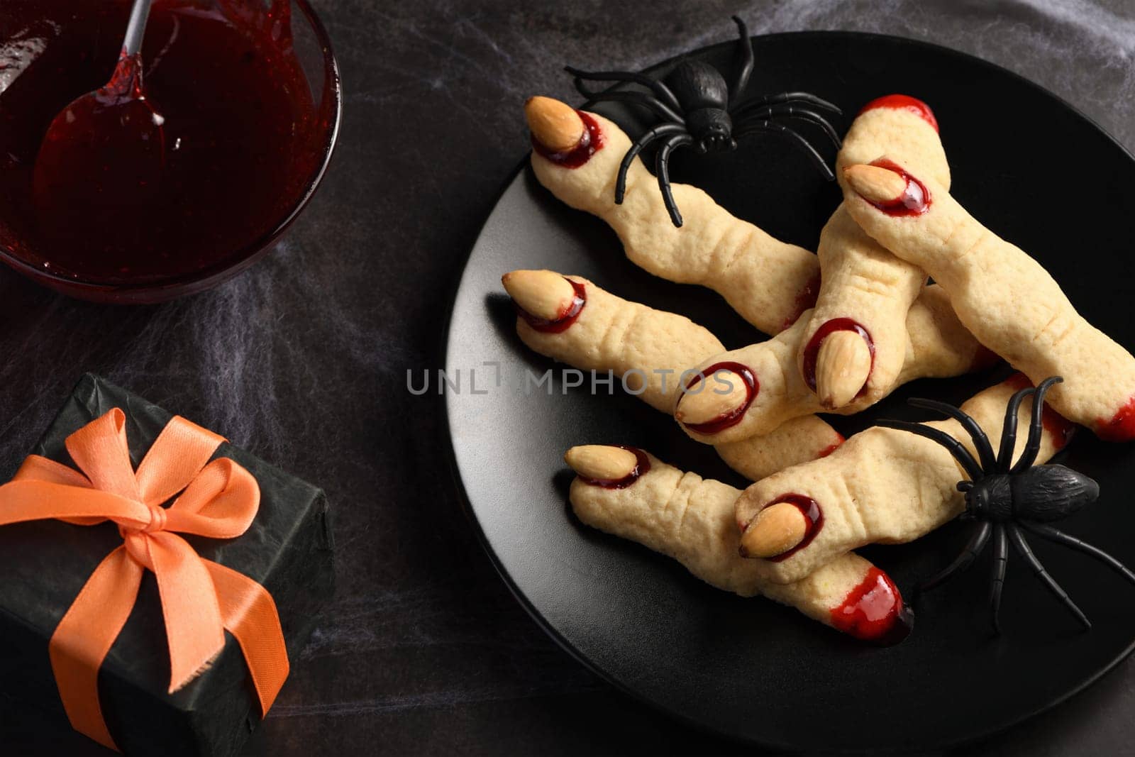 Creepy, scary Witch fingers made from sugar cookies with raspberry jam and almonds on Halloween. Trick-or-treat. Classic Cookie Witch Fingers takes on a healthy, gluten-free, paleo, vegan look.