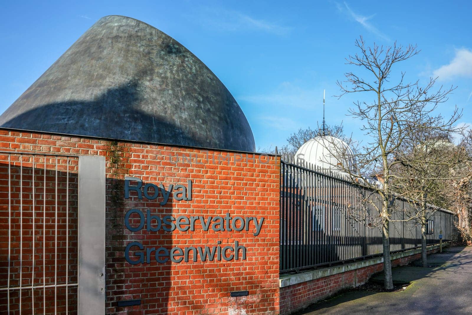 London, United Kingdom - February 02, 2019: Royal Observatory Greenwich label on brick wall near entrance, RGO, commissioned 1675 is best known for prime meridian that passes through. by Ivanko