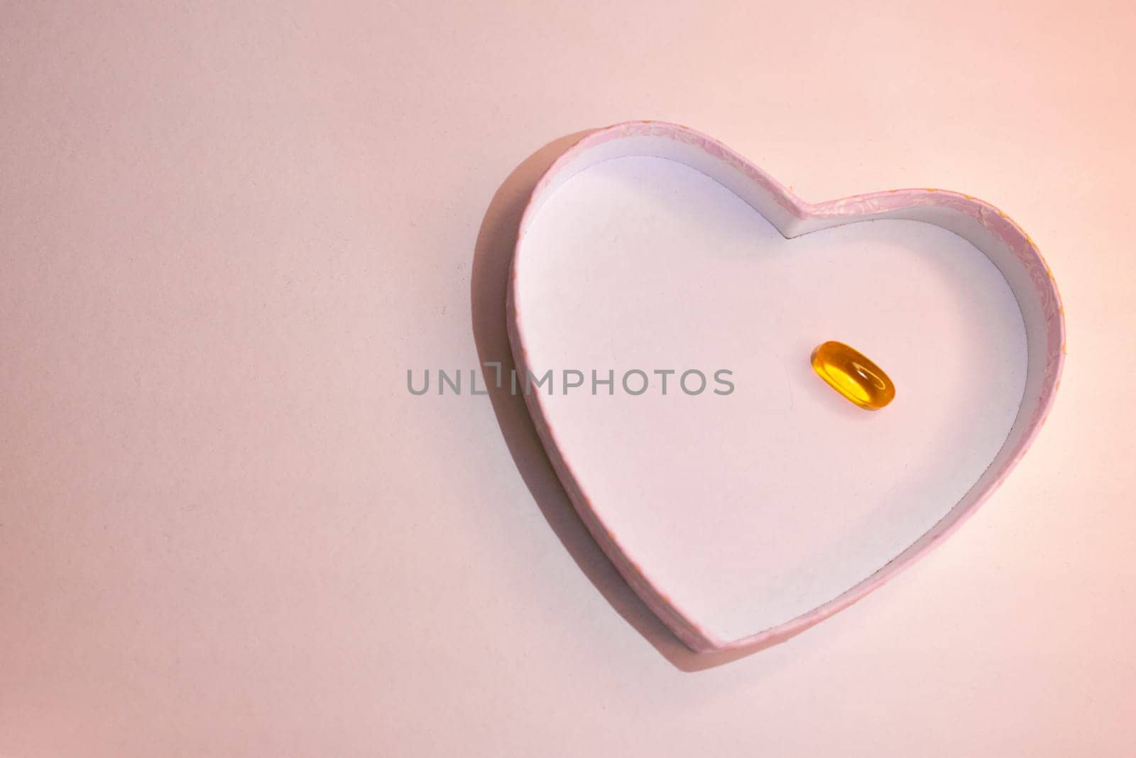 Top view or heart-shaped figure with transparent capsule. Sapace for text. by VeroDibe